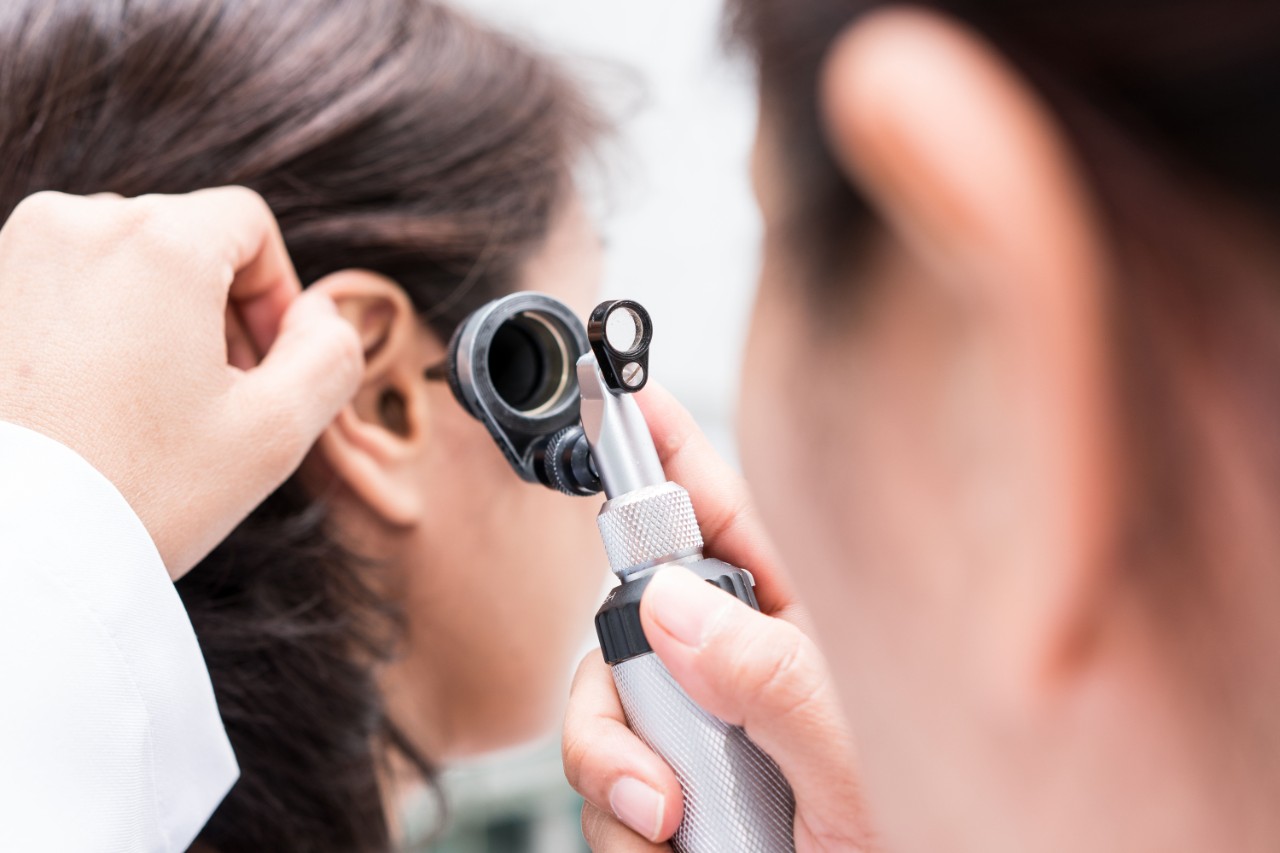 Provider looking in an ear