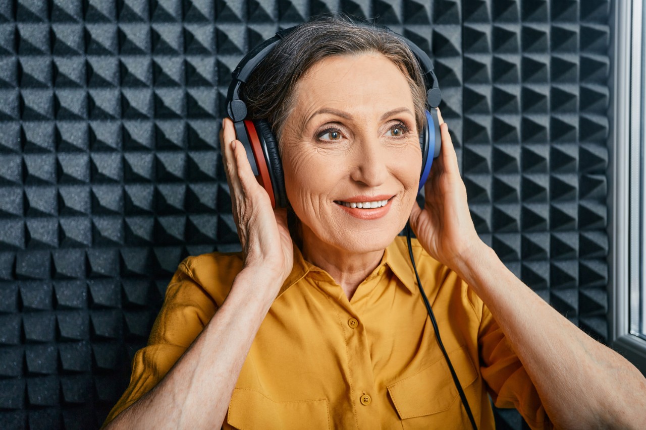 Senior woman wearing headphones taking a hearing test