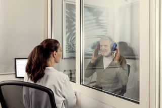Audiologist performing hearing test