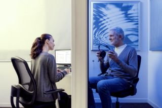 Asian girl holding a tablet while wearing headphones