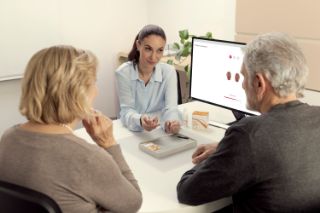 Audiologist showing hearing aids