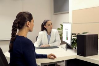 An elderly woman looking at the results of her hearing screening