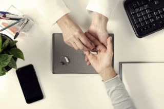 Provider giving patient hearing aids