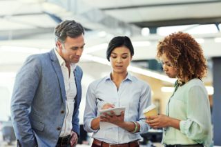 a couple looking at a woman taking notes
