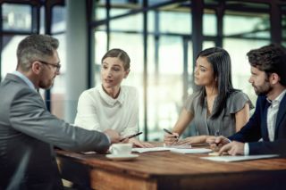 People having a business meeting around a table