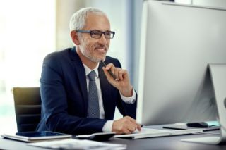 A man works on a computer in his office