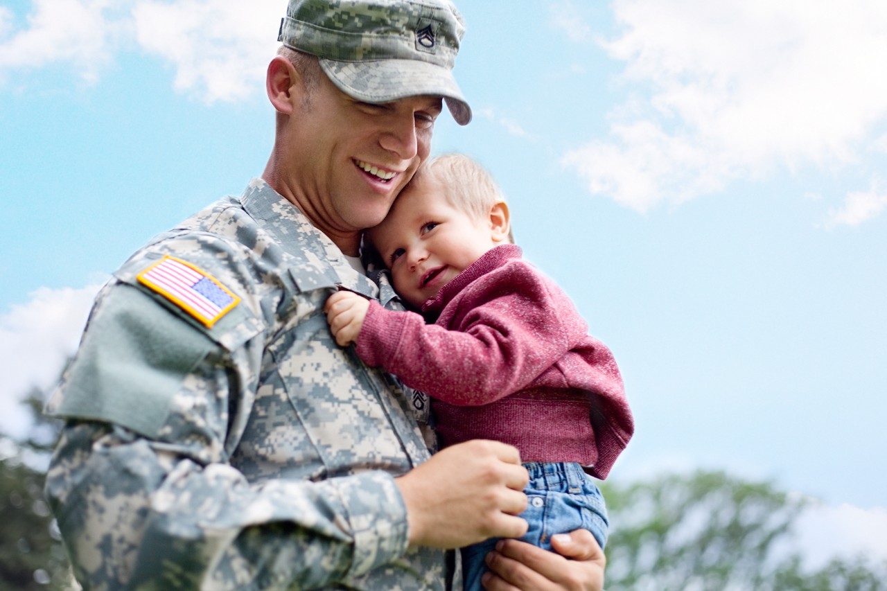 Soldier hugging son