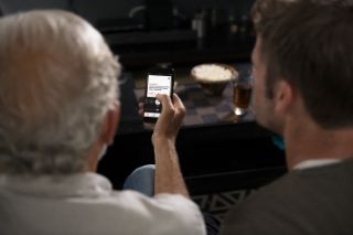 Two men looking using a smartphone app