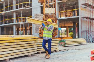 Man with beam on construction site