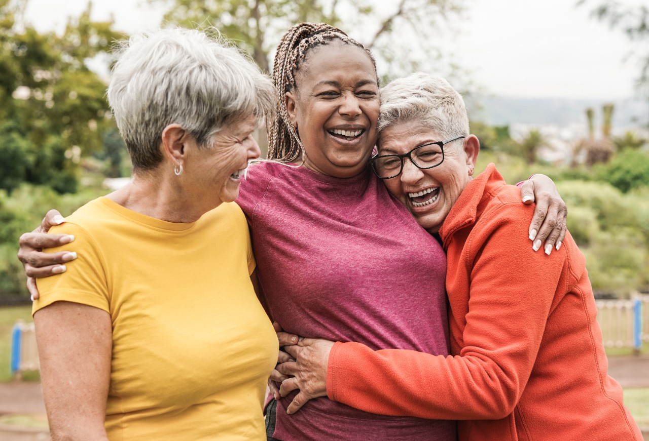 Three women hugging and smiling