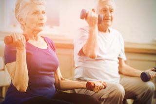 An elderly couple working out