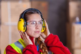 Woman working with earmuffs