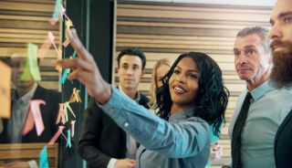 A businesswoman running a meeting with other colleagues