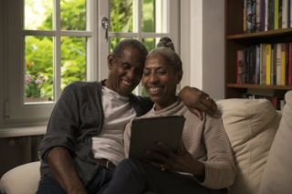 Couple on couch with tablet
