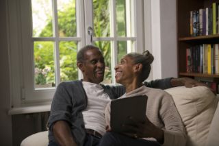 Couple on couch with tablet