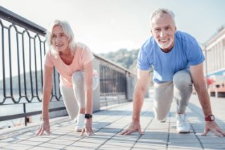 A senior couple preparing to run on the seaside
