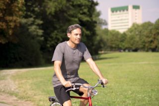 A man riding a bike in a park