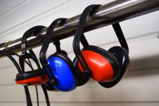 Several pairs of blue and red earmuffs 