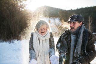 A senior couple enjoying the snow in the winter