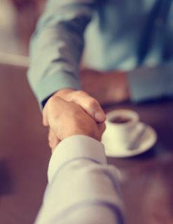 A businesswoman running a meeting with other colleagues