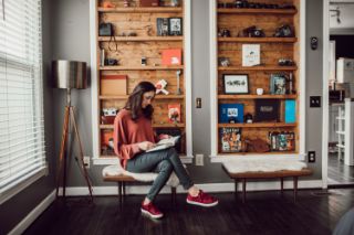 A young woman at home reading
