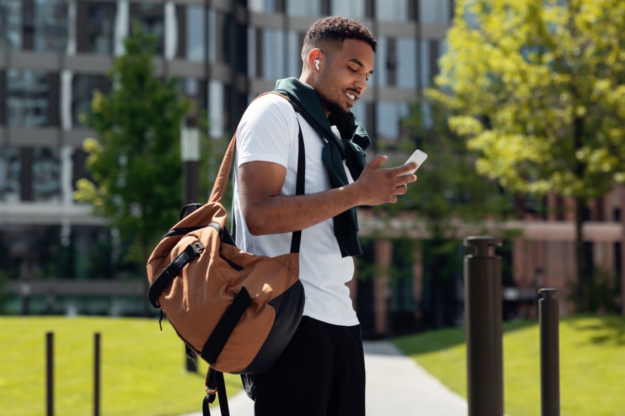 Man outdoors looking at his smartphone