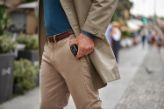 A man puts his hearing aid charger in his pocket