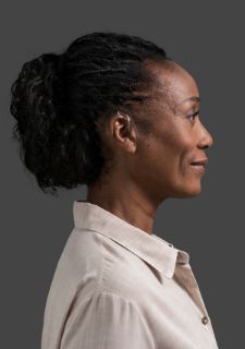 Woman wearing BTE hearing aid