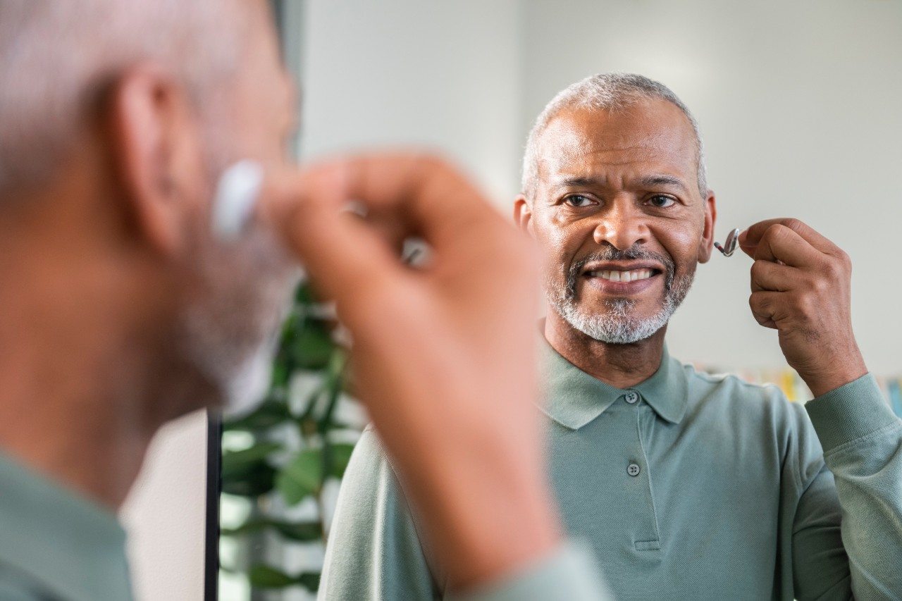 Man inserting hearing aid