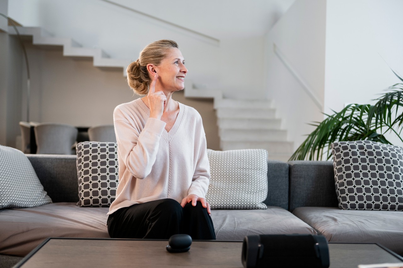woman smiling while wearing a hearing aid