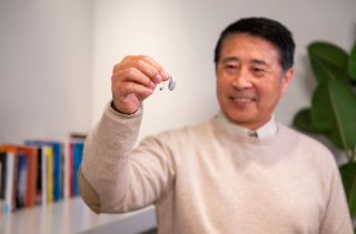 Man holding a hearing aid