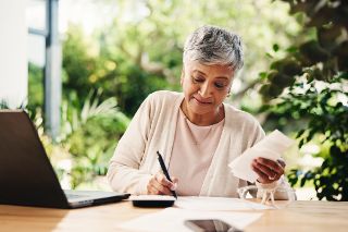Elderly woman writing