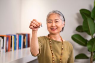 woman holding hearing aid