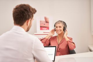 Elderly woman taking a hearing test