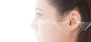 Side profile of a woman with a digital sound wave graphic overlaid on her ear