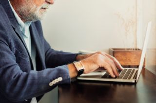 Hands touching a laptop